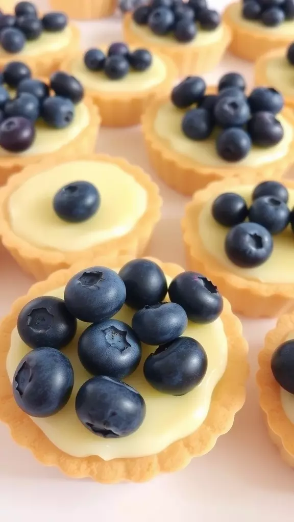 Close-up of individual blueberry lemon pies topped with fresh blueberries.